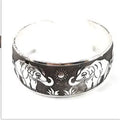 Open design Miao ethnic bracelet in silver alloy with carved turtle or elephant motif.