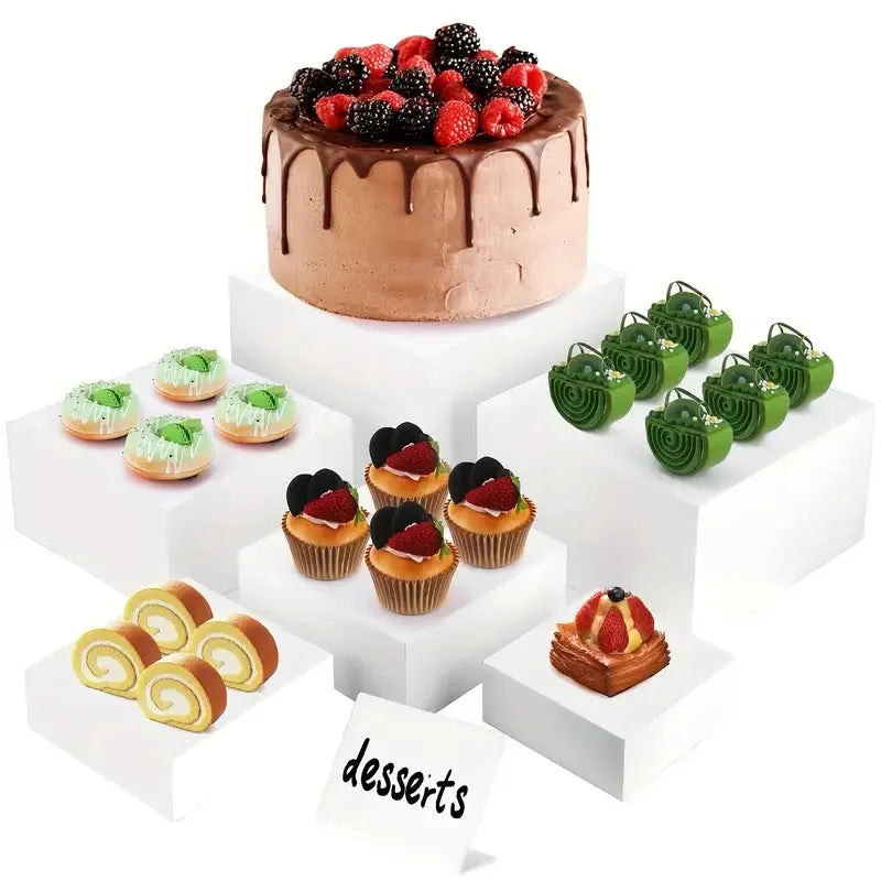 White plastic suit cube dessert display stand 6-piece set arranged in tiered configuration on tabletop