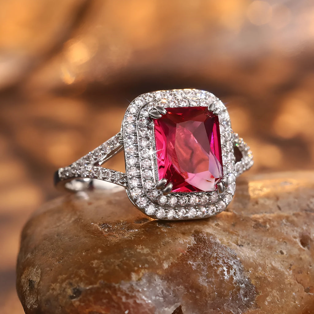 Copper square ring with a large red princess-cut rhinestone on a model's finger.