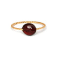 Geometric shaped agate ring for women in a solid colour on a neutral background.