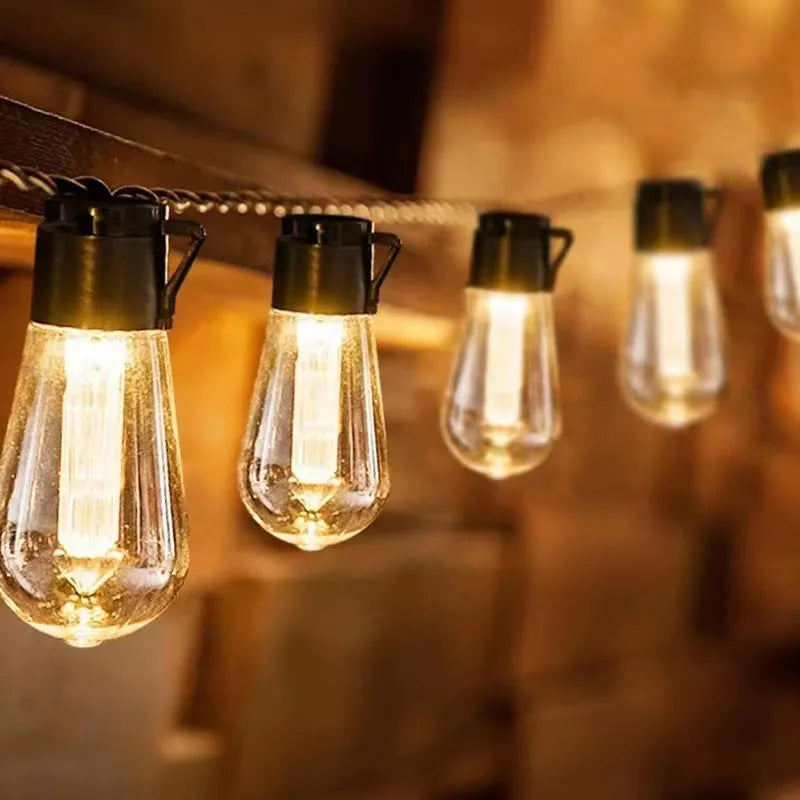 Solar powered outdoor string lights with retro long bulb infusion bottle shapes on 10 metre cable
