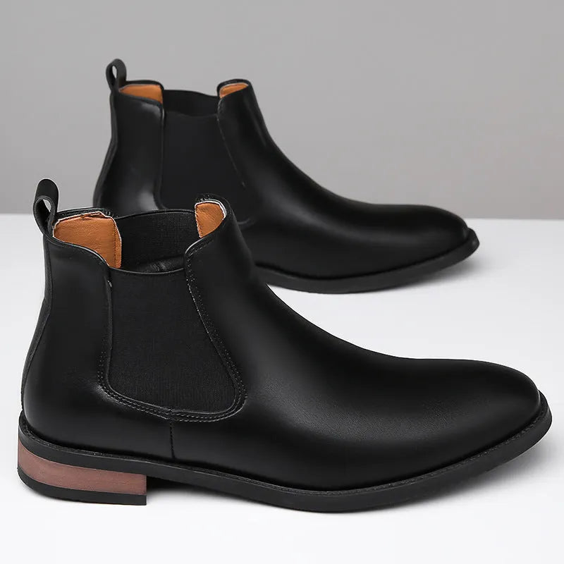 Men's black Chelsea boots with round pointed toe and visible stitching detail