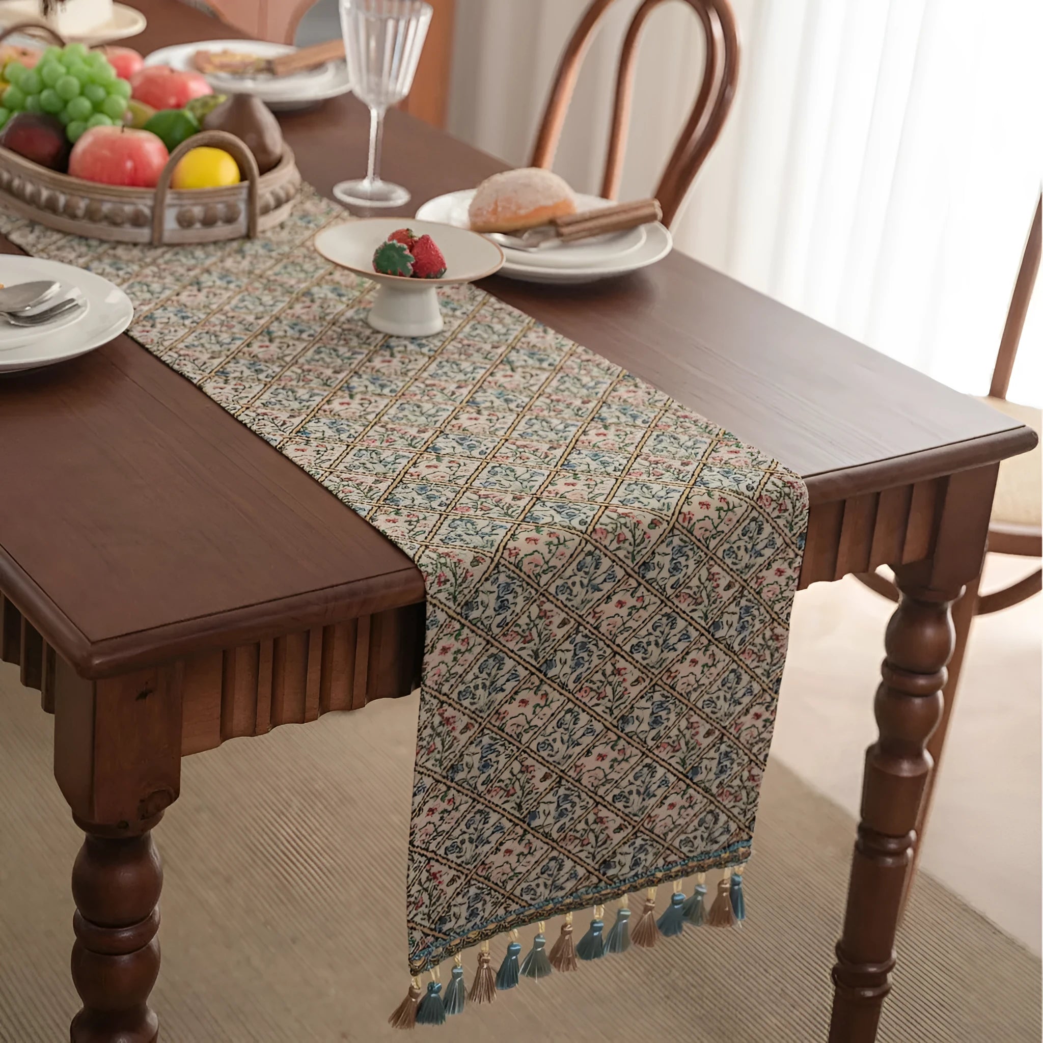 Nordic jacquard bouquet pattern table runner with tassel trim in dark blue on a dining table.