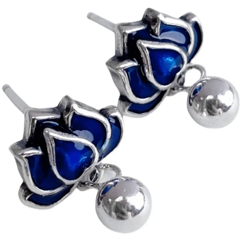 Blue lotus earrings with flower-shaped studs and artistic lotus seedpod tassel dangle