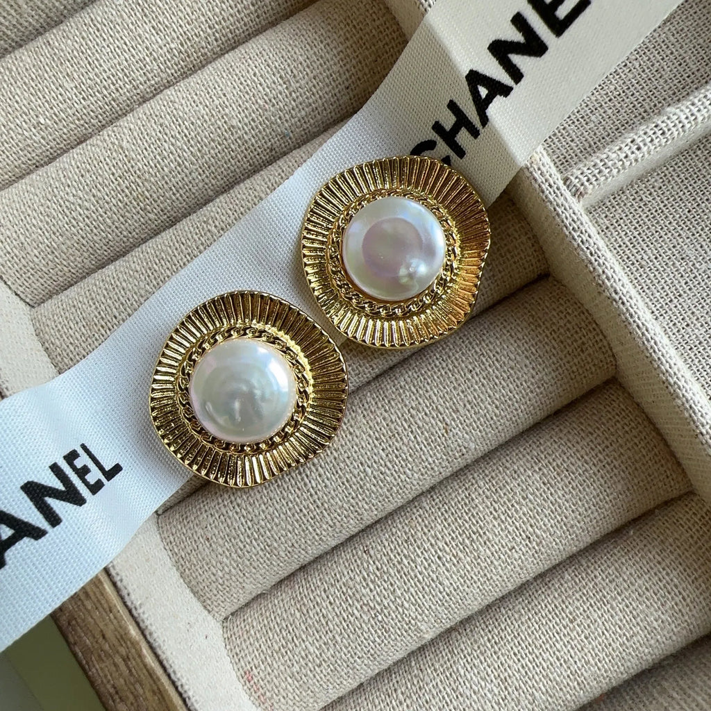 A pair of round gold-coloured retro earrings for women with a simple design.