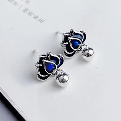 Blue lotus earrings with flower-shaped studs and artistic lotus seedpod tassel dangle