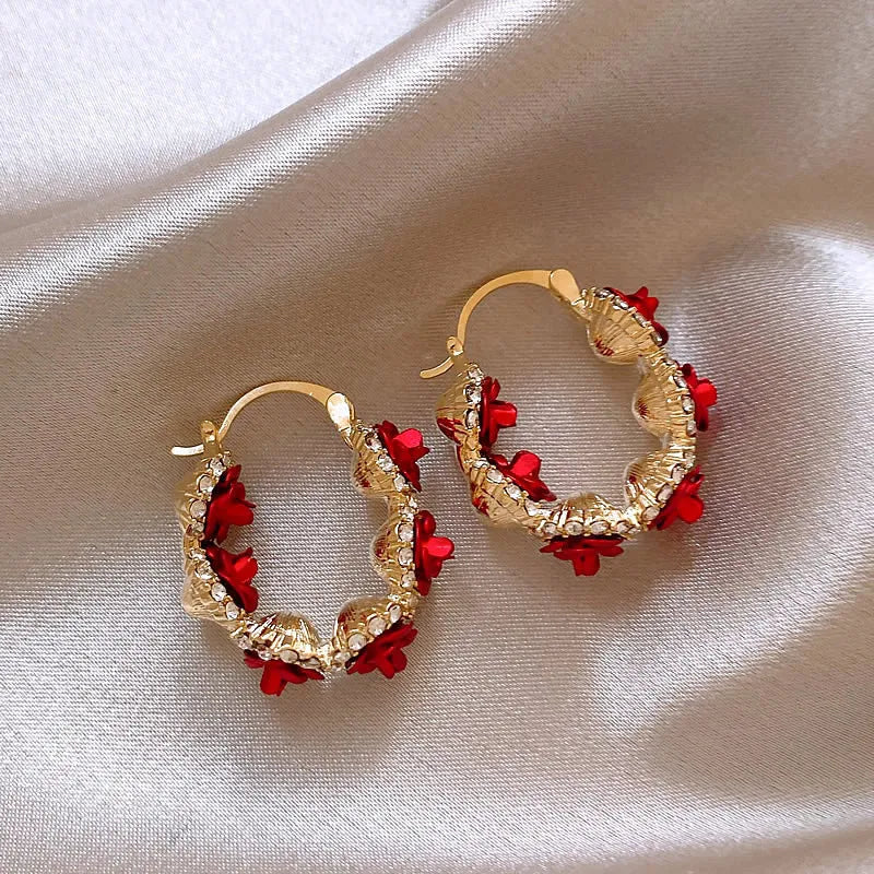 Red floral alloy ear clips with rose design and clip fastening