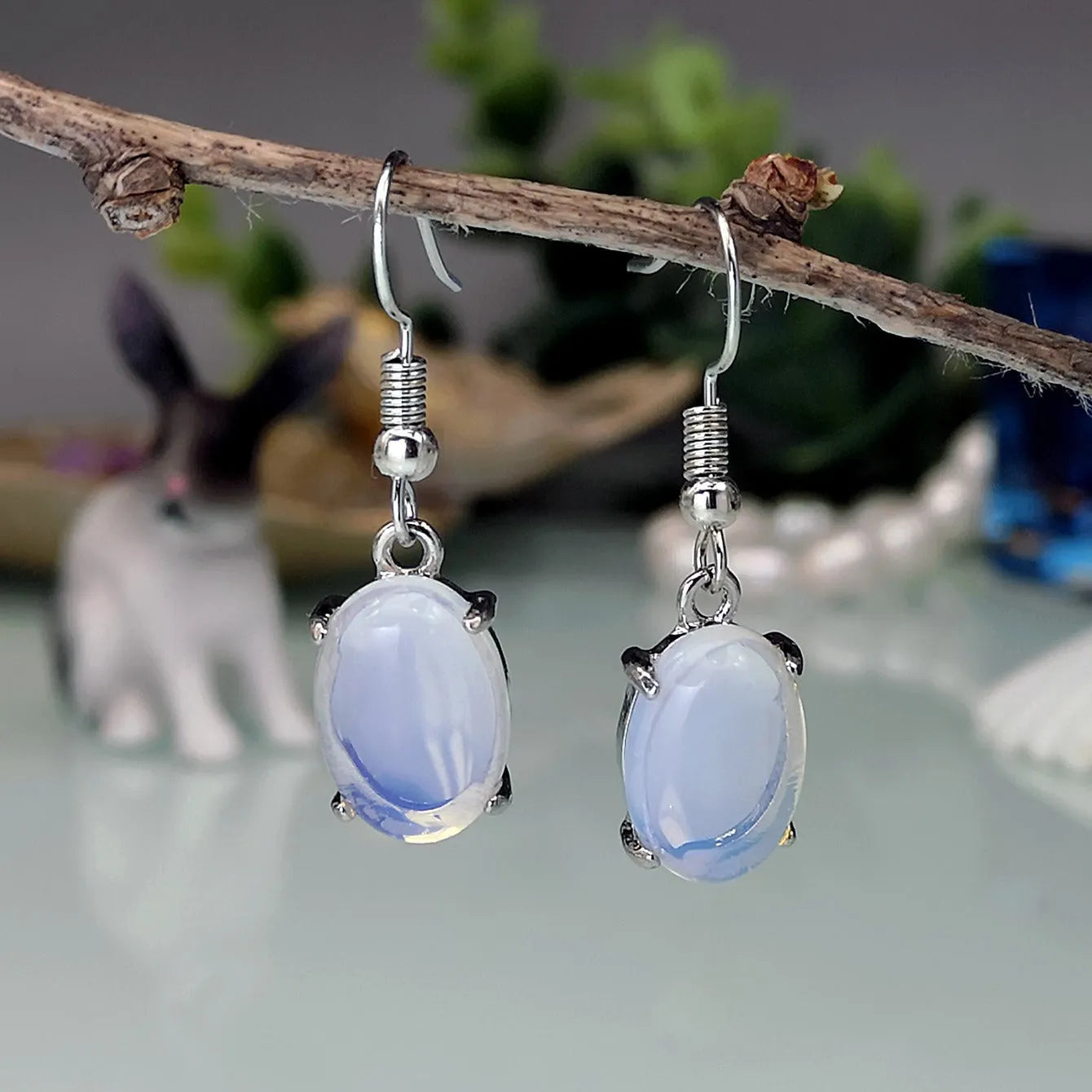Moonlight white opal earrings with retro cross design and drop shape featuring ellipse elements