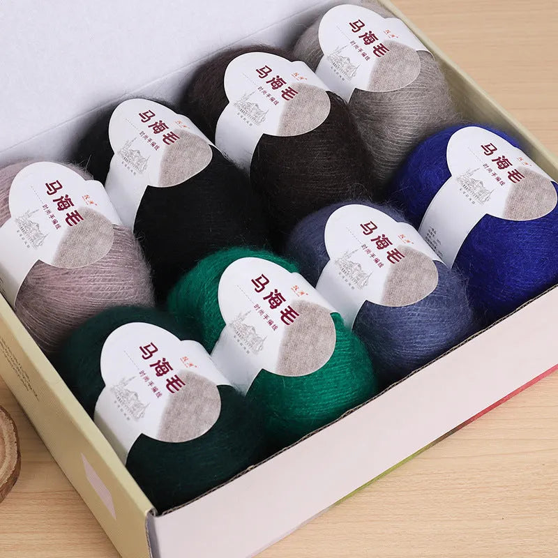 A ball of hand-woven mohair wool yarn for a DIY scarf knitting kit in one of 34 available colours.