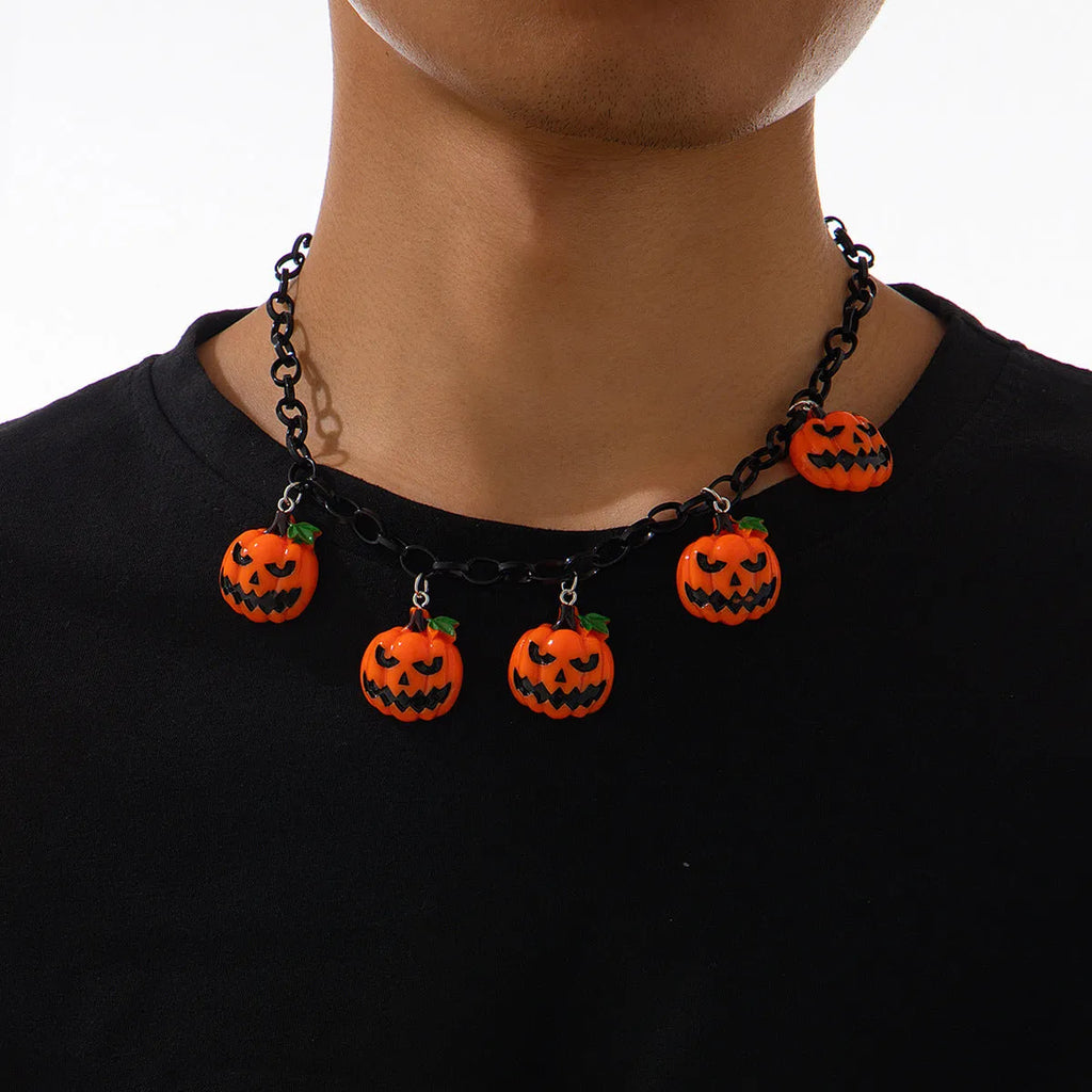 Halloween necklace with a colourful acrylic ghost and pumpkin cartoon pendant on a chain.