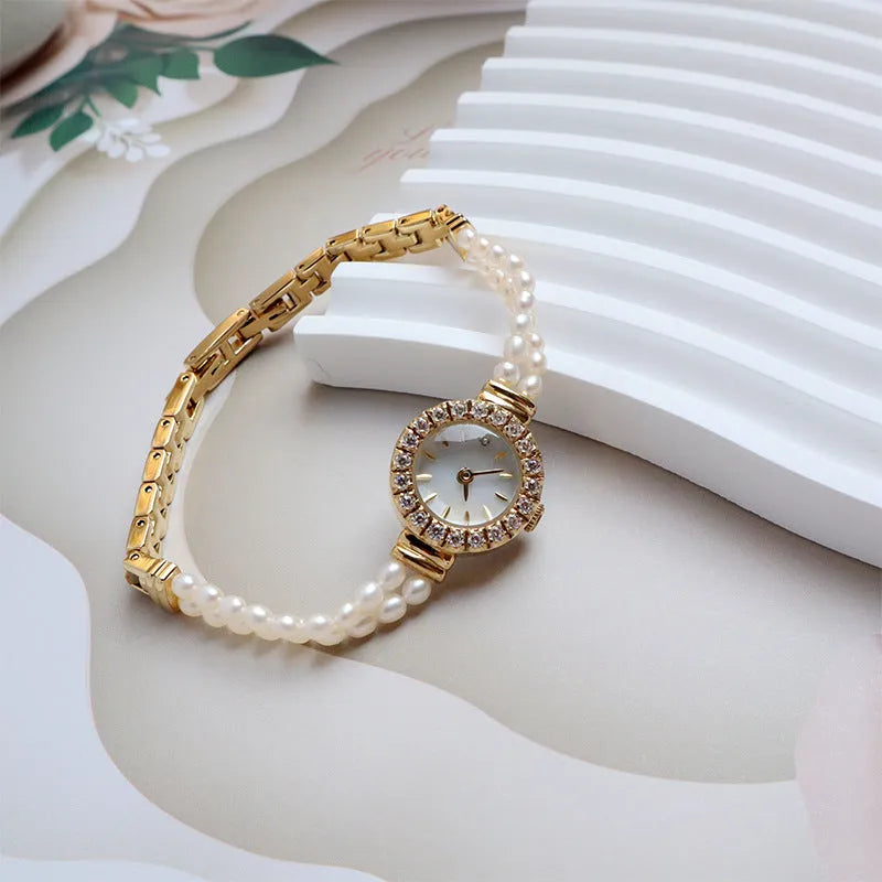 Light gold women's bracelet watch with freshwater pearls and a round dial
