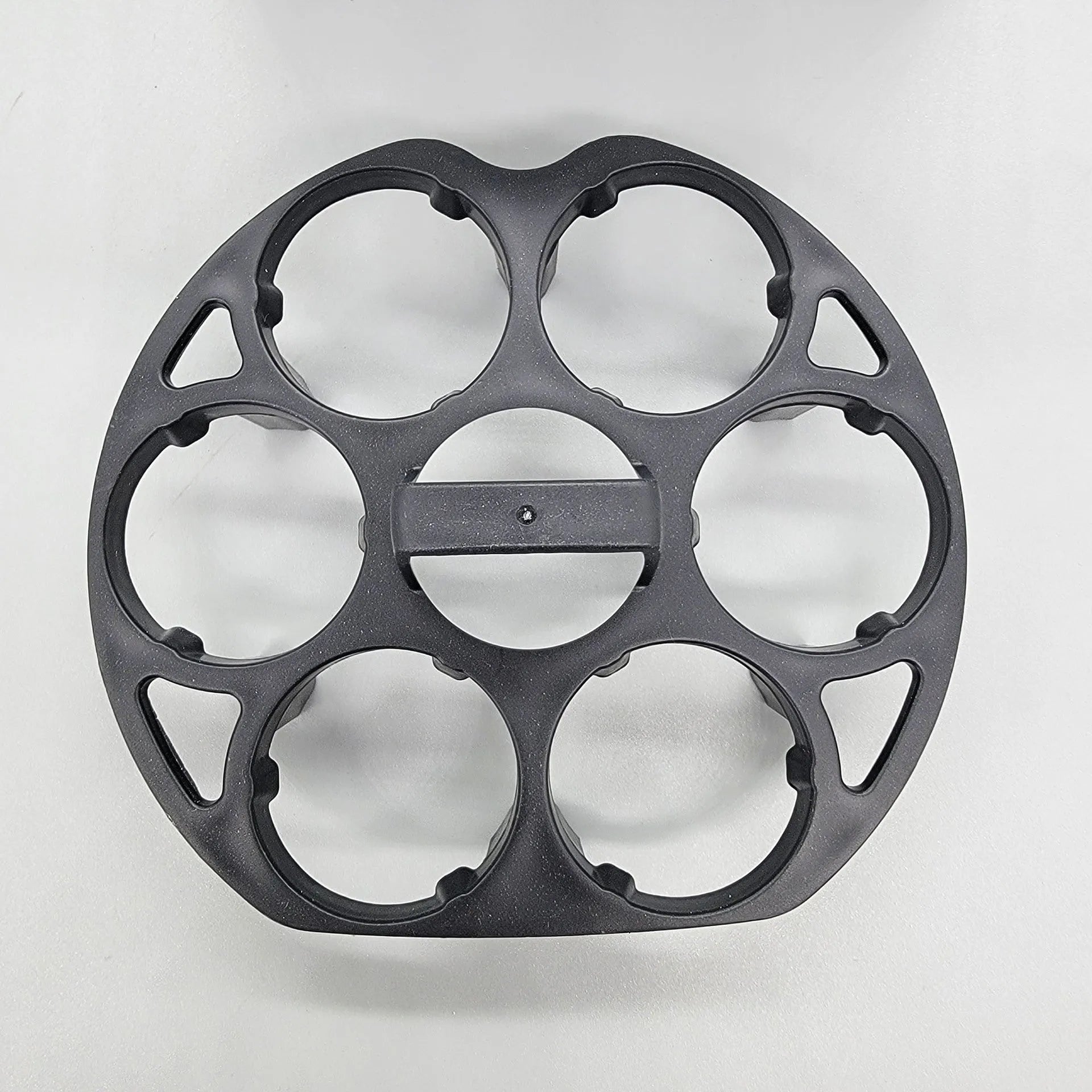 Black modern plastic egg holder rack on a kitchen surface.