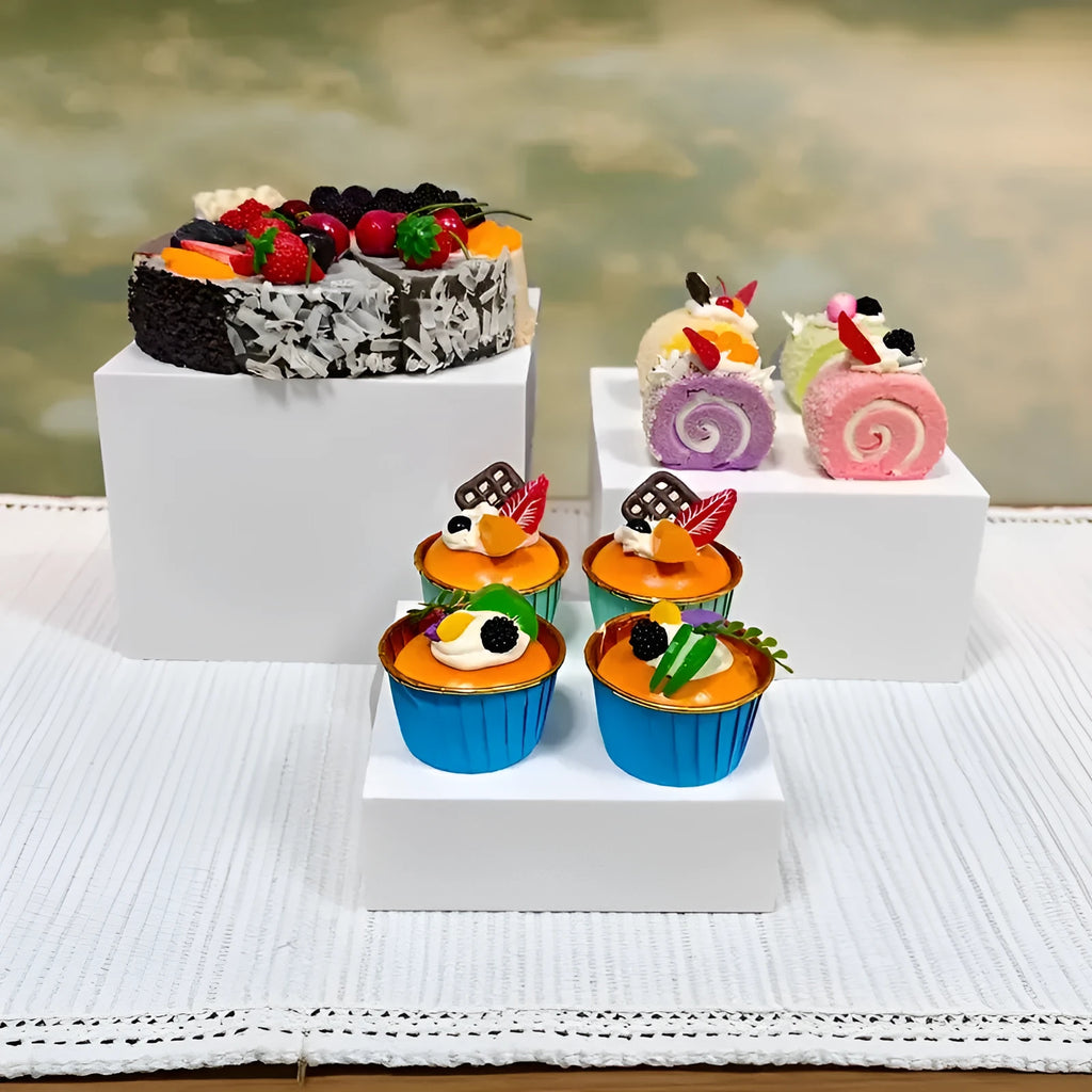 White plastic suit cube dessert display stand 6-piece set arranged in tiered configuration on tabletop