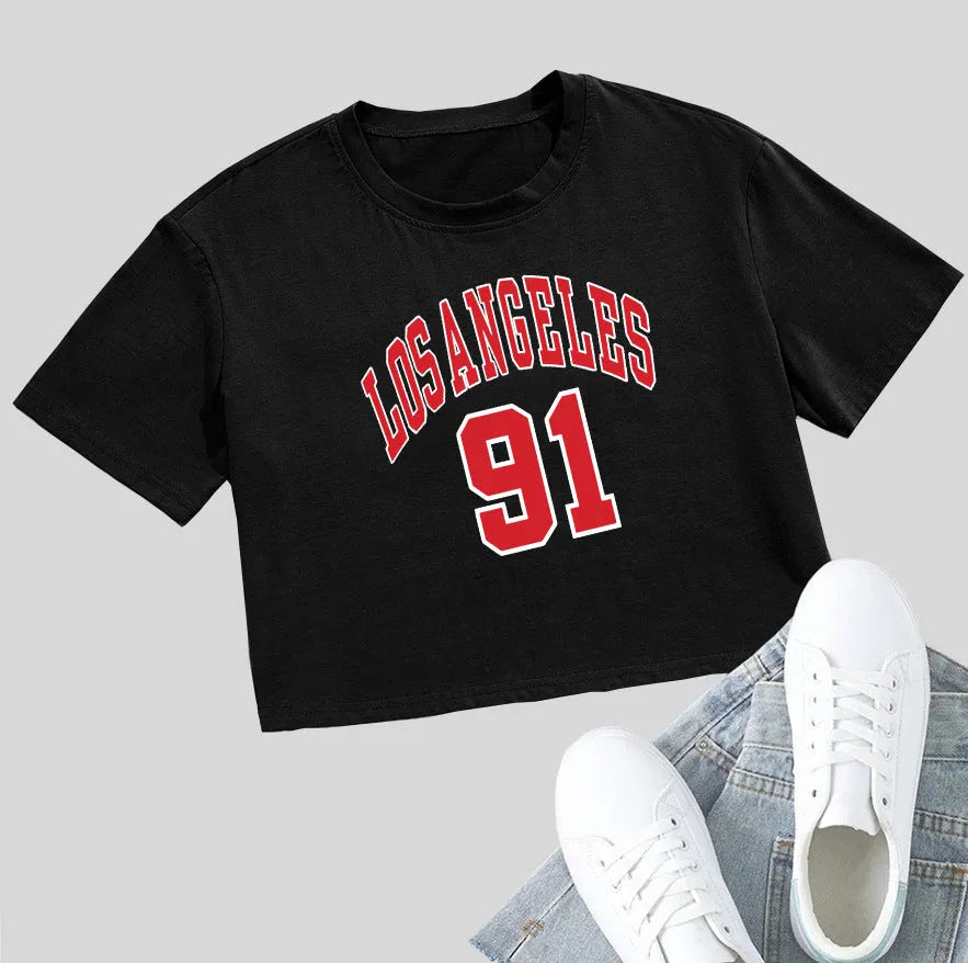 Black loose-fit cotton crop top t-shirt with printed white English letters, short sleeves, and an exposed navel.