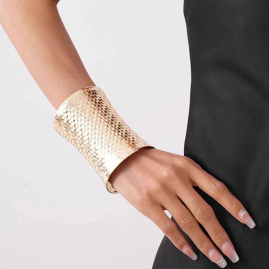 Women's vintage bracelet with large round gold charm on wrist