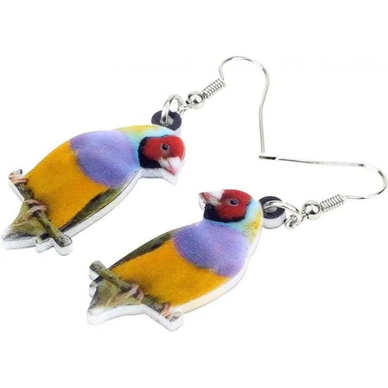 A pair of blue titmouse pendant earrings made from acrylic with printed snake and geometric designs.