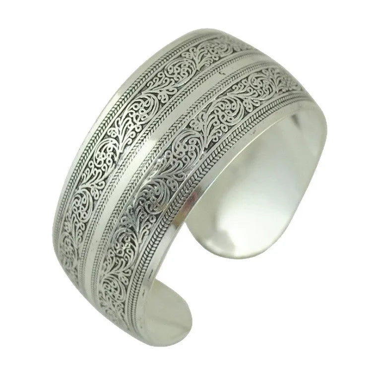 Open design Miao ethnic bracelet in silver alloy with carved turtle or elephant motif.