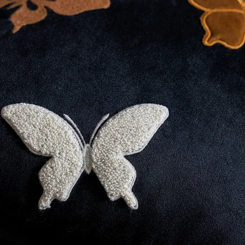 Square beige, black, and purple cushion with embroidered Chinese butterfly pattern.