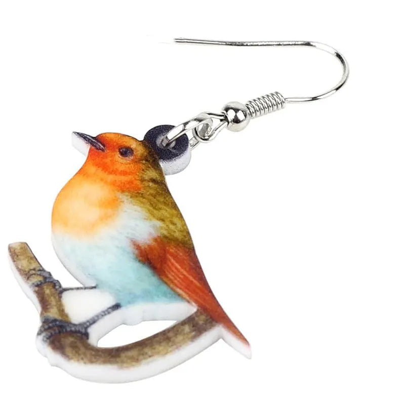 Blue Titmouse bird pendant drop earrings made from acrylic with geometric and snake design details.