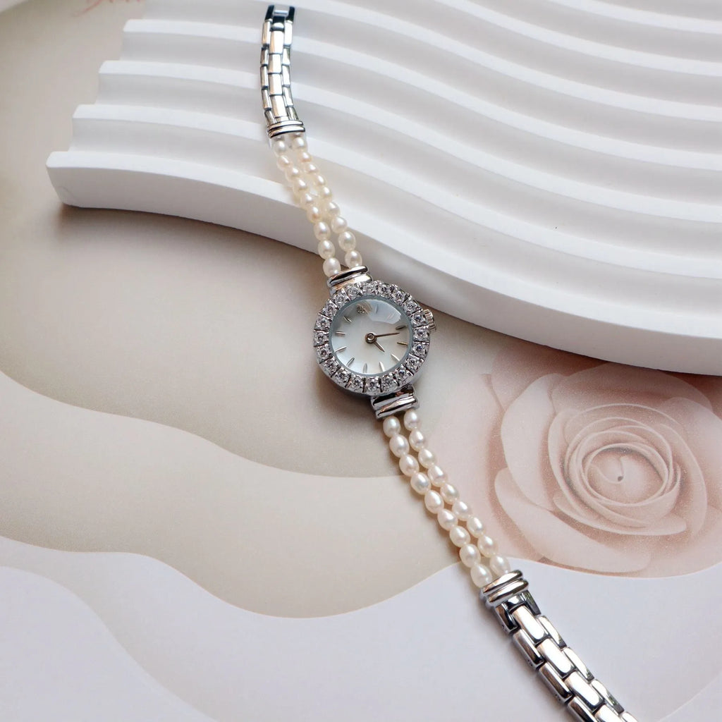 Light gold women's bracelet watch with freshwater pearls and a round dial