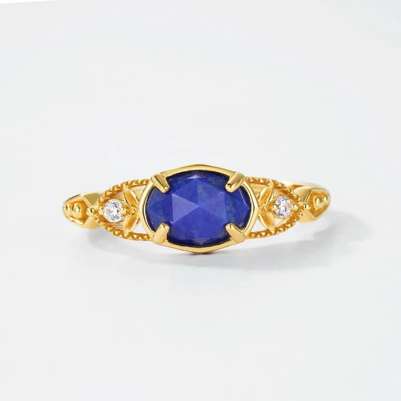 Geometric oval silver-tone alloy ring with a deep blue lapis lazuli centre stone.