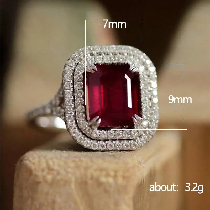 Copper square ring with a large red princess-cut rhinestone on a model's finger.
