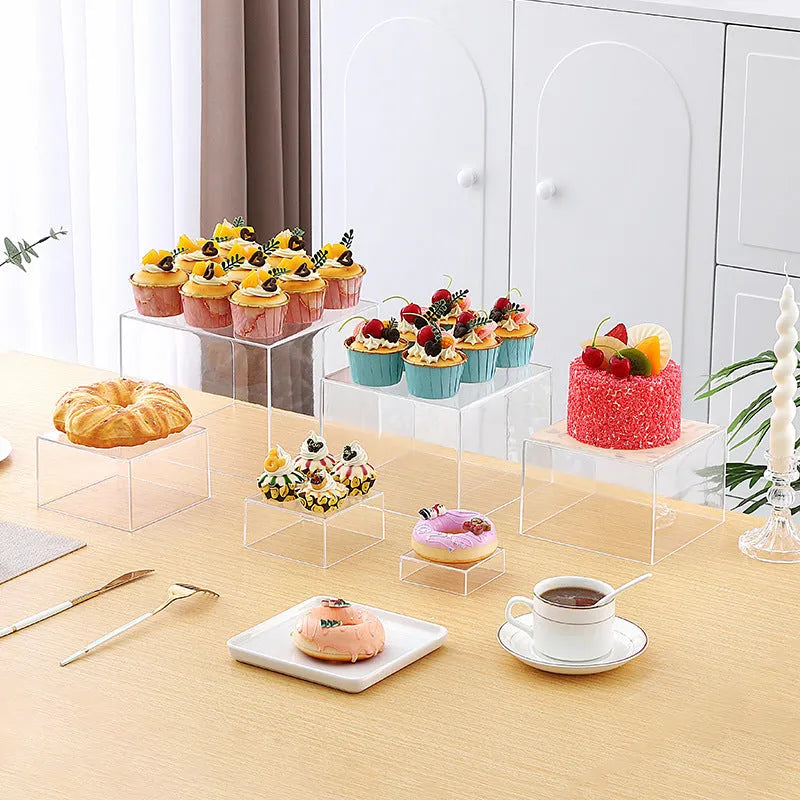 White plastic suit cube dessert display stand 6-piece set arranged in tiered configuration on tabletop