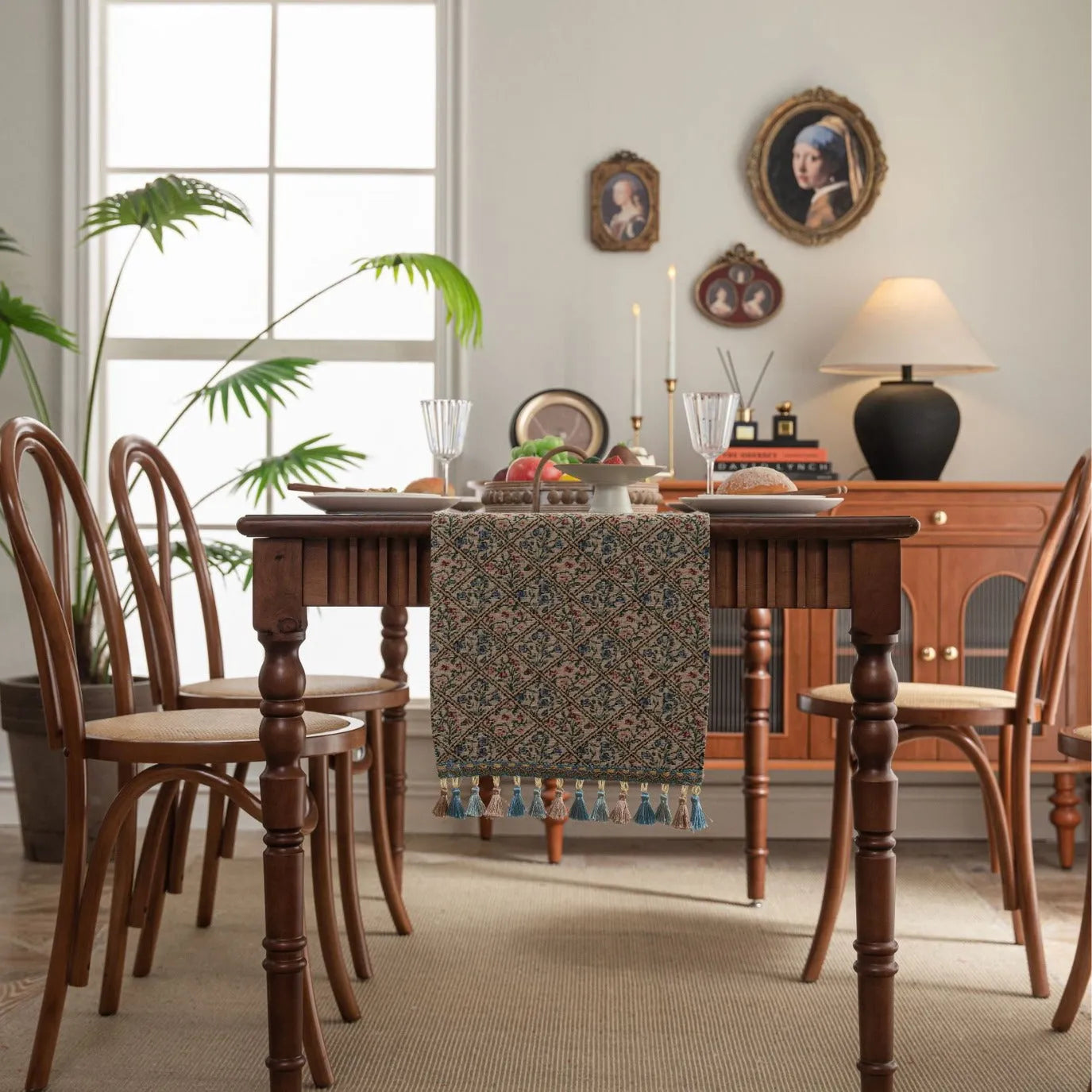 Nordic jacquard bouquet pattern table runner with tassel trim in dark blue on a dining table.