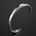 Open-ended stainless steel bracelet with inlaid zircon crystals in a choice of rose gold, gold, or steel colour finish.