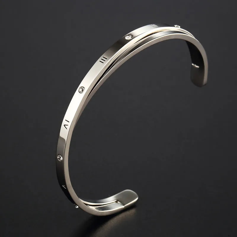 Open-ended stainless steel bracelet with inlaid zircon crystals in a choice of rose gold, gold, or steel colour finish.