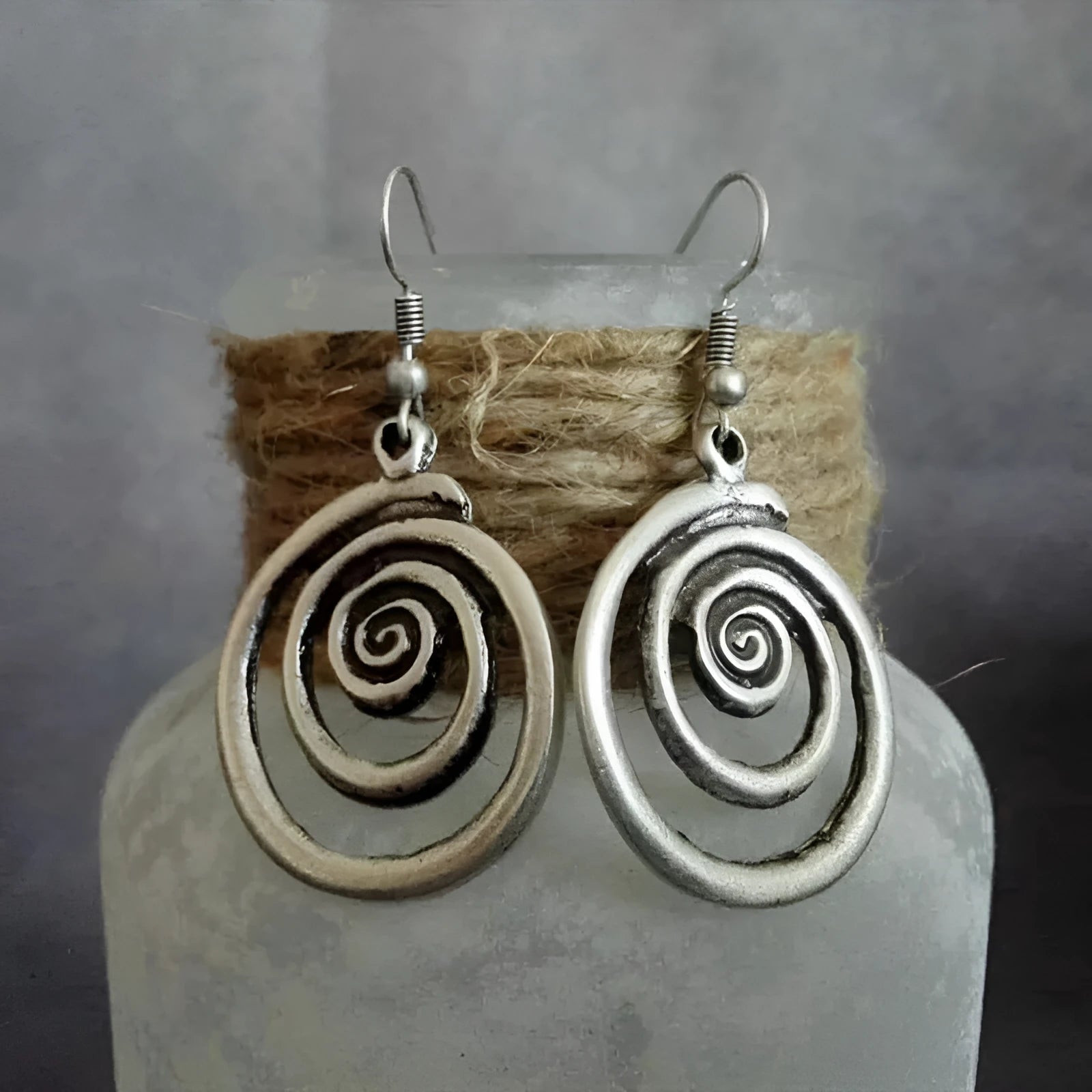 Geometric spiral distressed earrings in silver alloy with retro design measuring 2.6 by 5 cm
