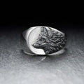 Silver geometric wolf head men's ring made from alloy metal on a grey background.