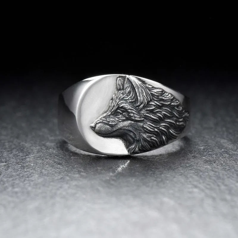 Silver geometric wolf head men's ring made from alloy metal on a grey background.