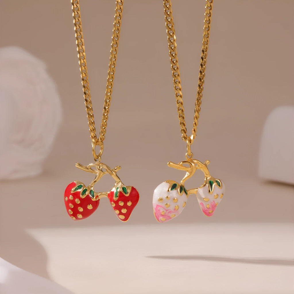 Close-up of a women's strawberry fruit pendant necklace with a detailed alloy charm on a stainless steel chain.
