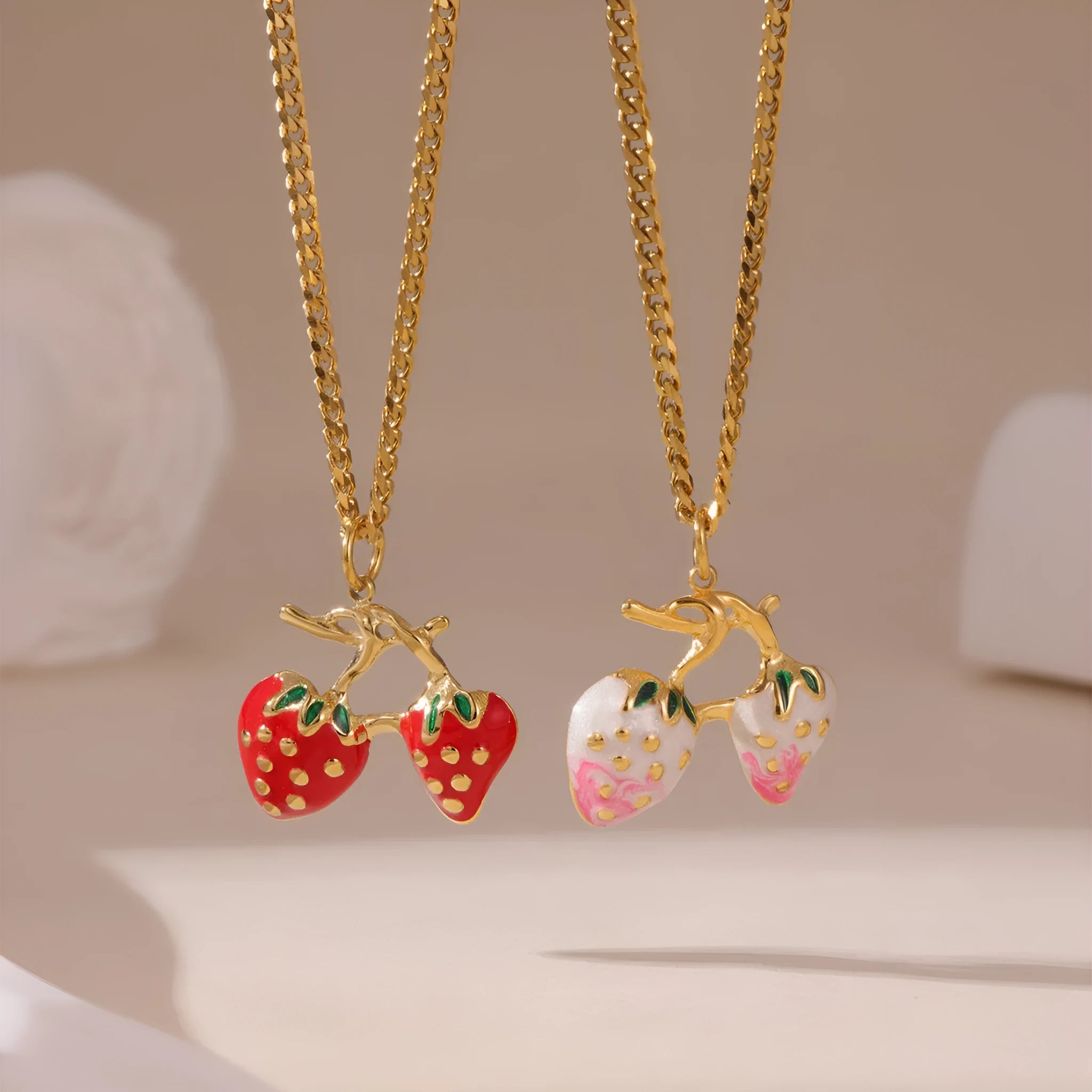 Close-up of a women's strawberry fruit pendant necklace with a detailed alloy charm on a stainless steel chain.