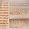 108-piece gold and yellow geometric round pearl earrings multipack on a flat surface.