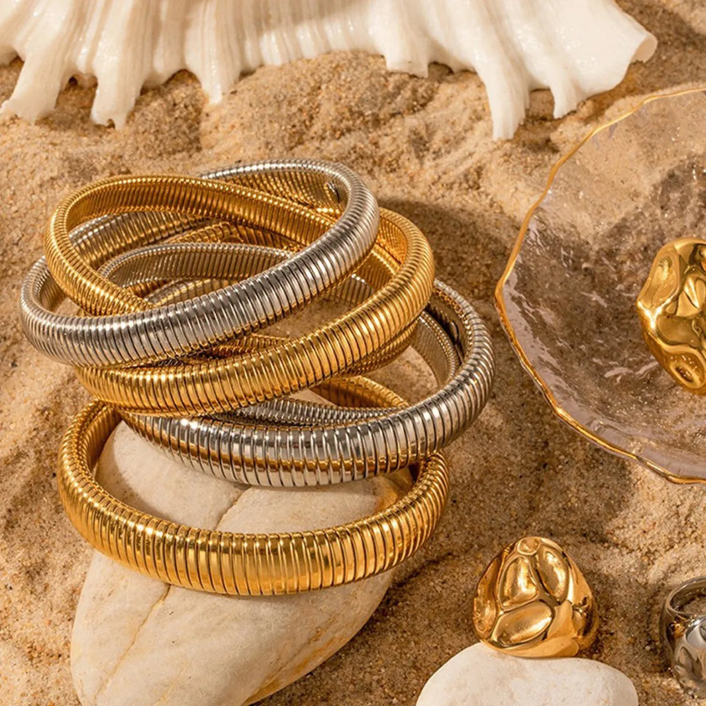 Women's elastic titanium steel bracelet with vertical stripe ring design in gold finish