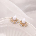 A pair of silver-toned retro fan-shaped drop earrings with a needle opal centre and sparkling rhinestone details.