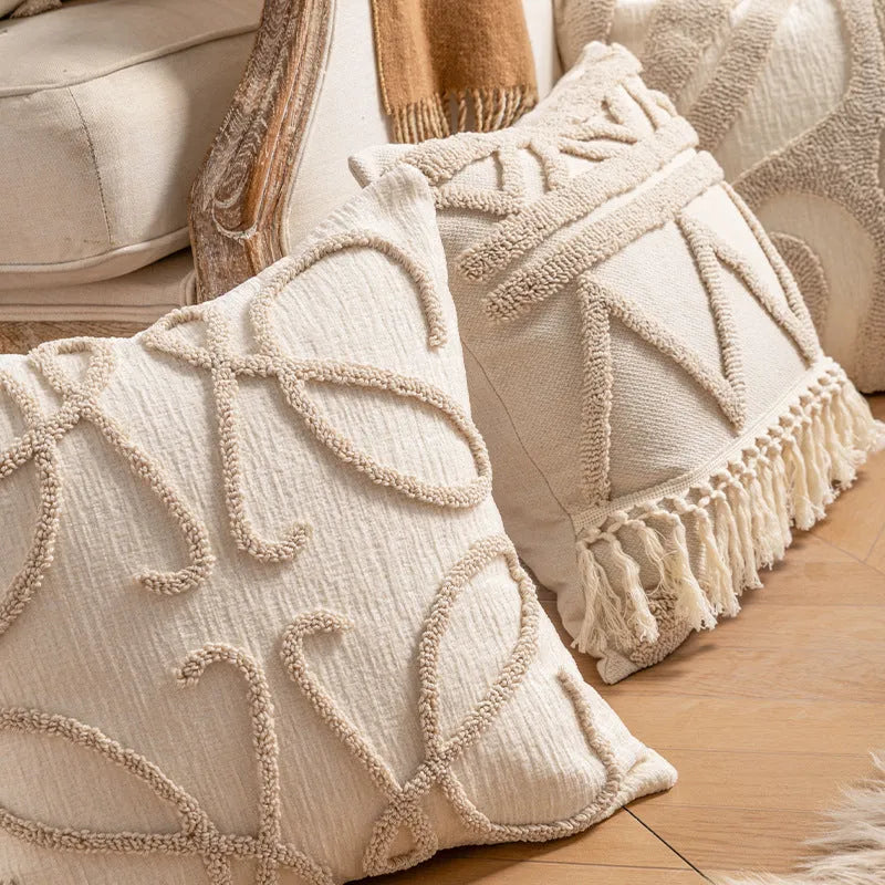 Knitted sofa pillow cover with tassel detailing in spiral dot pattern