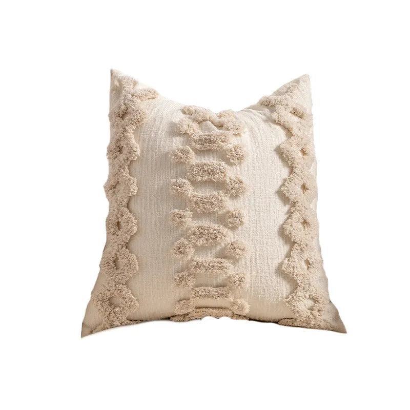 Knitted sofa pillow cover with tassel detailing in spiral dot pattern