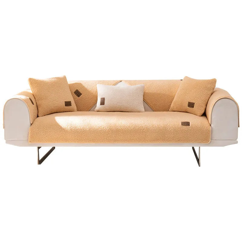 Solid colour lambswool sofa cover draped over a sofa, showing simple style and cloth liner.