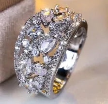 Women's hollow round copper fashion ring shown in gold and platinum with white diamond or blue sapphire accents.