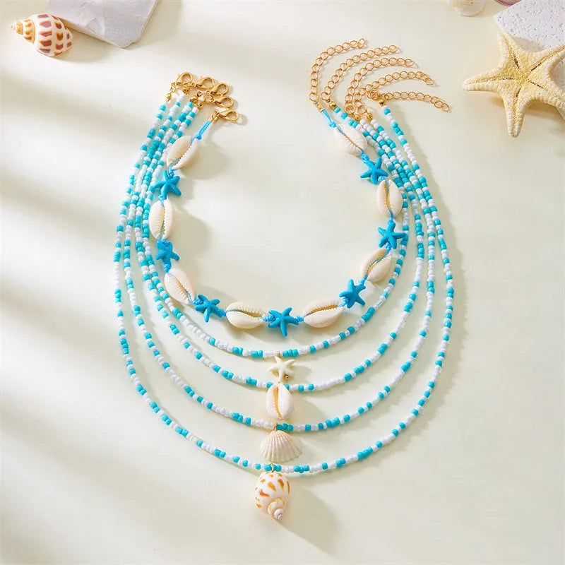 Five women's necklaces with starfish shell conch bead designs in blue and multicolour with alloy pendants