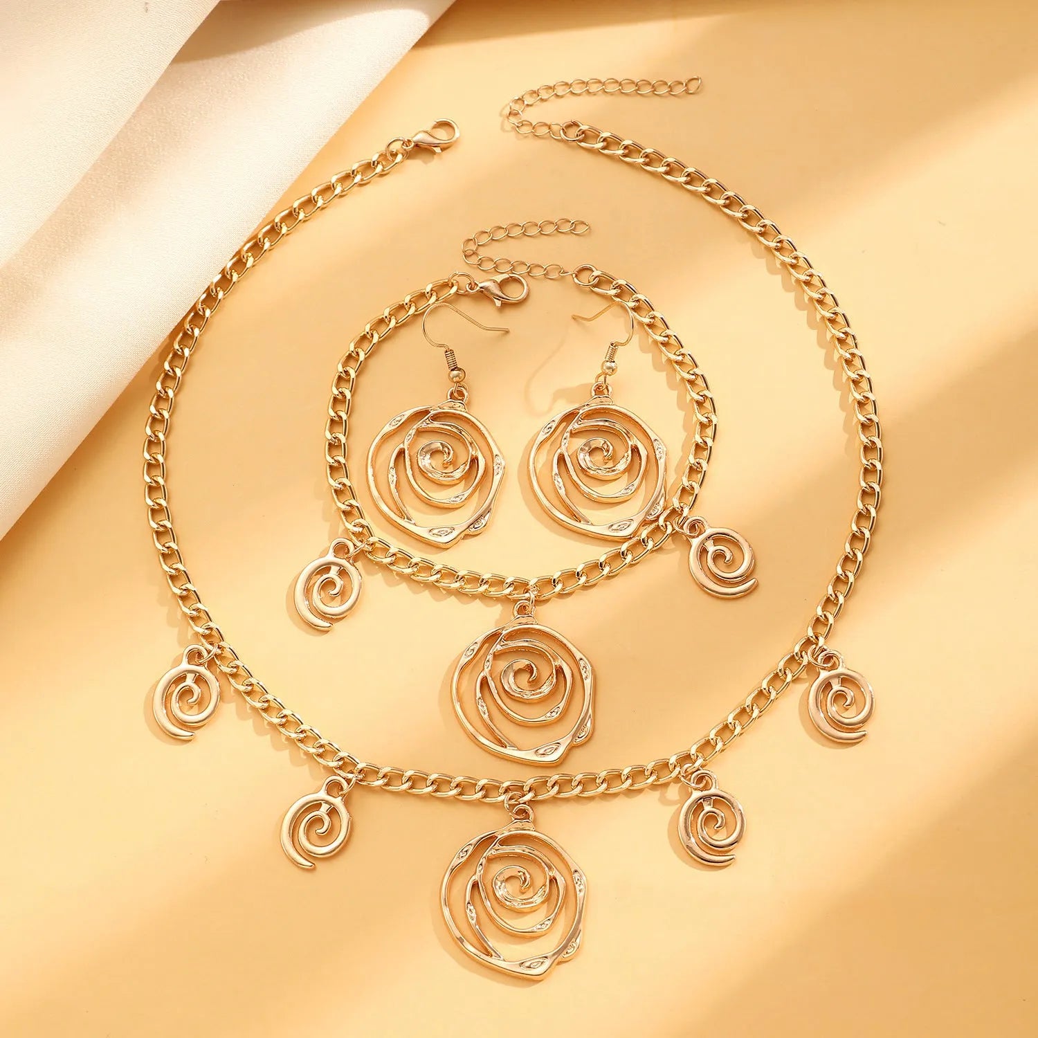 Spiral donut jewellery set showing necklace, bracelet and ear hooks with geometric circle design