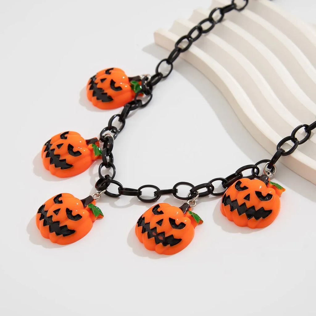 Halloween necklace with a colourful acrylic ghost and pumpkin cartoon pendant on a chain.