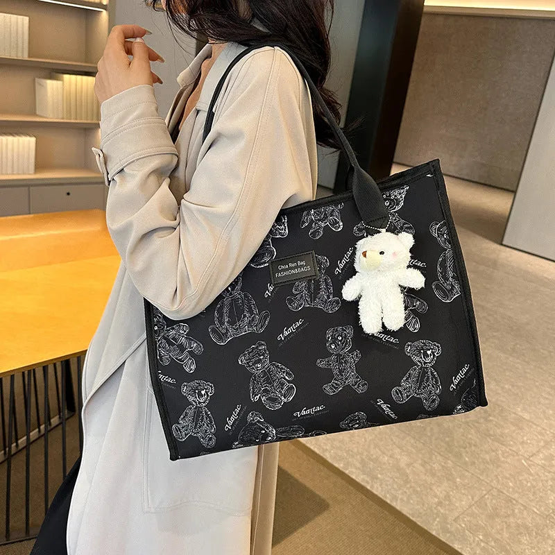 Women's black canvas tote bag with rhombus pattern, horizontal shape and shoulder strap