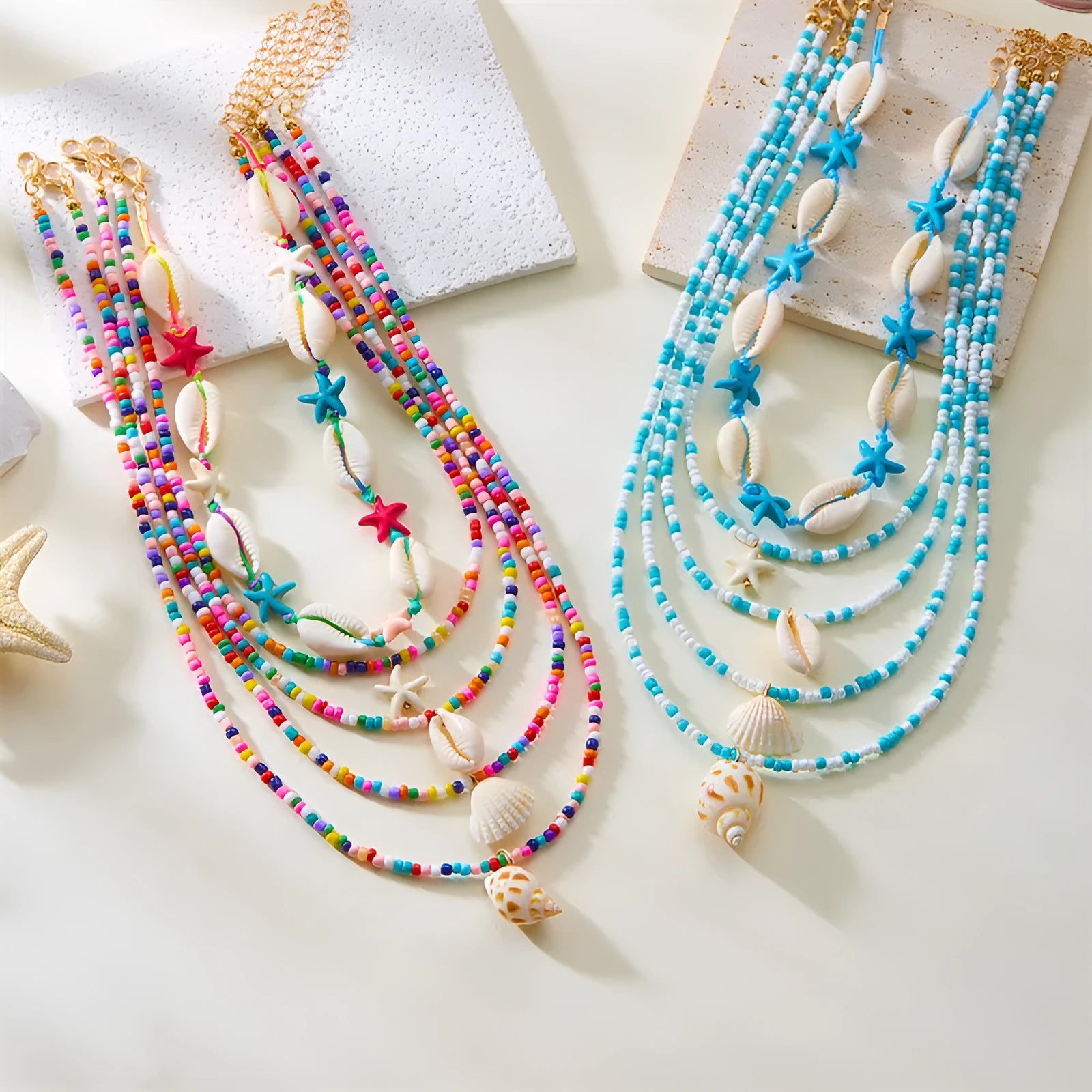 Five women's necklaces with starfish shell conch bead designs in blue and multicolour with alloy pendants