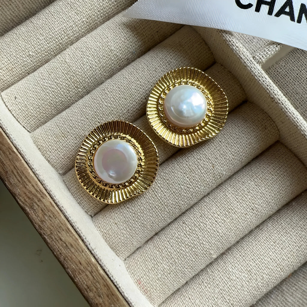 A pair of round gold-coloured retro earrings for women with a simple design.