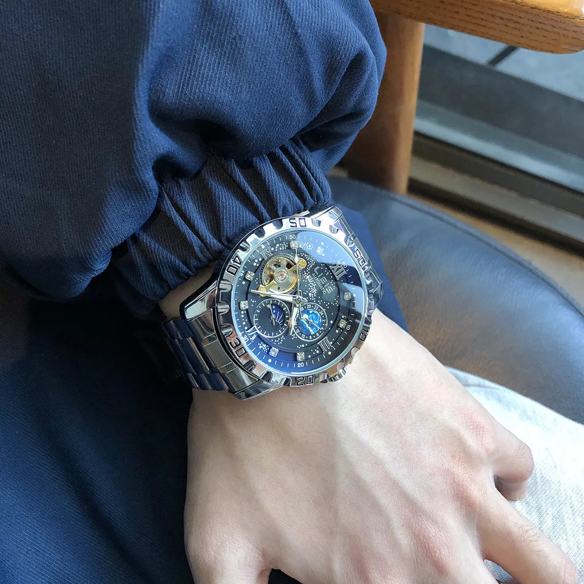 Men's silver case automatic watch with black starry luminous dial and steel belt