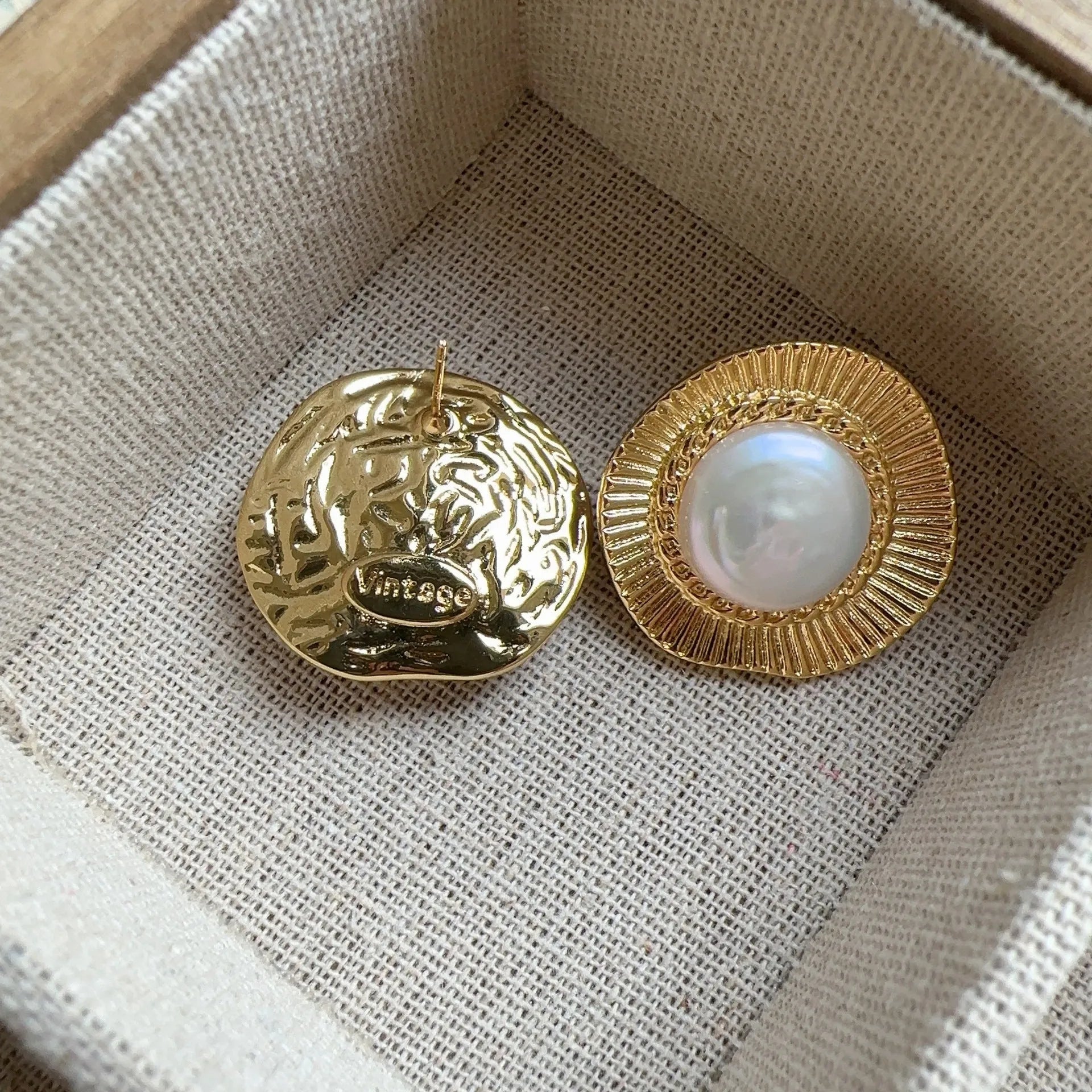 A pair of round gold-coloured retro earrings for women with a simple design.